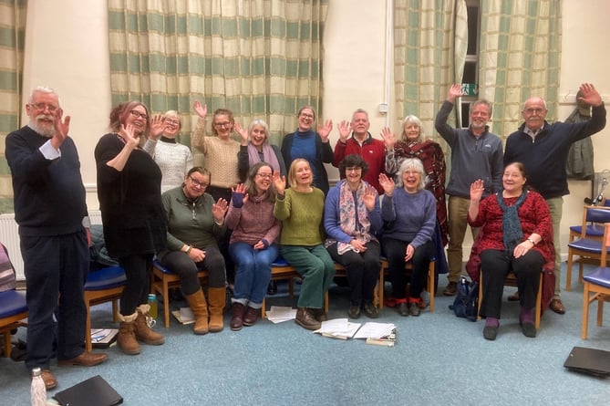 Roland Smith (far left) who has conducted the choir throughout the last 40 years and Dr Willis (second left) at a rehearsal where she shared some ideas about the new piece. 
