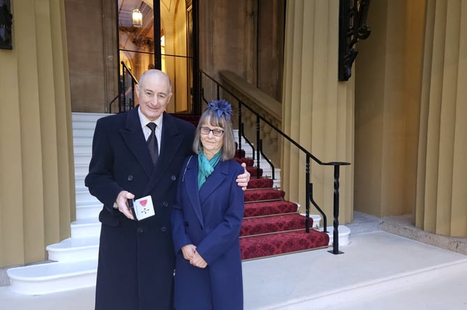 Dennis Mardon holding his MBE, pictured with his wife Helen after leaving Buckingham Palace.
