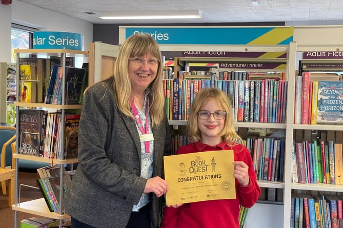 Julia Moxey receiving her Gold Secret Book Quest certificate from Crediton Library Supervisor Sue Lee.  AQ 6081
