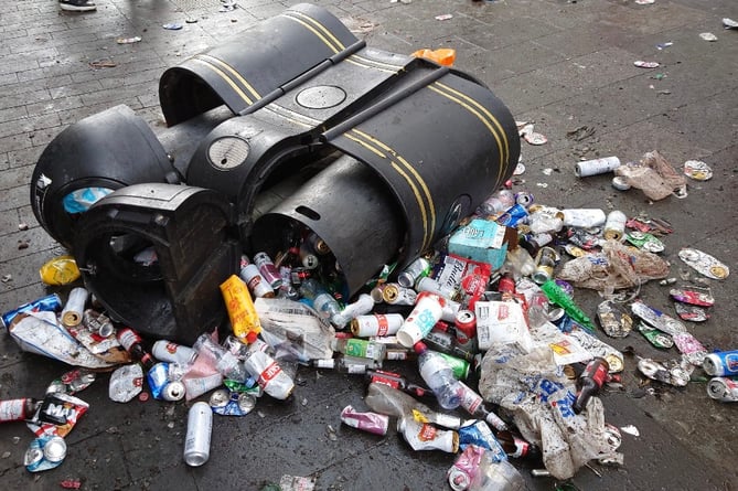A generic overflowing litter bin.