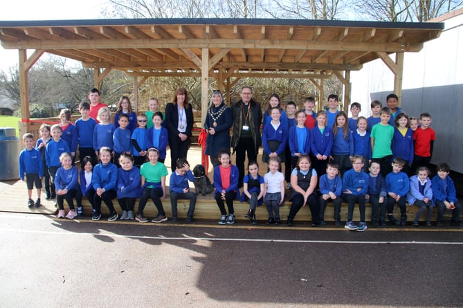 The Mayor of Crediton, centre, with Head Teacher Mrs Debbie Maine and the school dog with Crediton Rector, Rev Matthew Tregenza and some of the children from each class before the ribbon to open the Outdoor Classroom was cut.  AQ 3794
