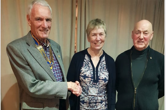 Pam Atkinson is welcomed as a Rotarian by Rotary Club of Crediton Boniface President Garry Adams, with, right, Rotarian Paul Fallon.
