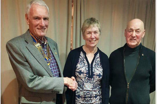 Pam Atkinson is welcomed as a Rotarian by Rotary Club of Crediton Boniface President Garry Adams, with, right, Rotarian Paul Fallon.