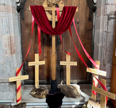 The display titled 'Sharing Our Sorrow', part of the Easter Trail at Crediton Parish Church.
