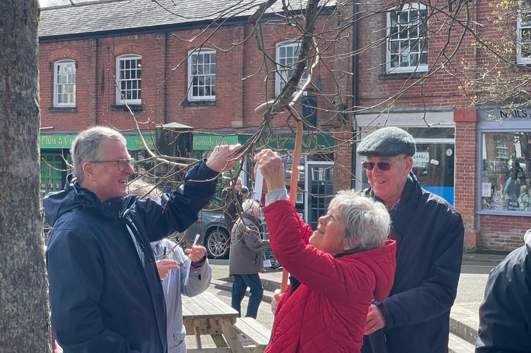 Tying a prayer to a tree in the Town Square. AQ 9087