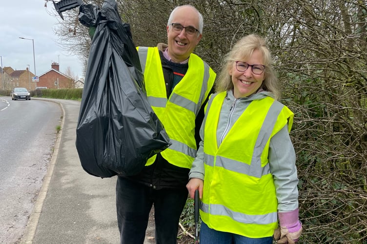 Two volunteers with their bag of collected litter. AQ 7962