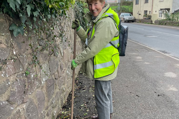 Cllr Natalia Letch brushing up near Copplestone Cross.  AQ 7988
