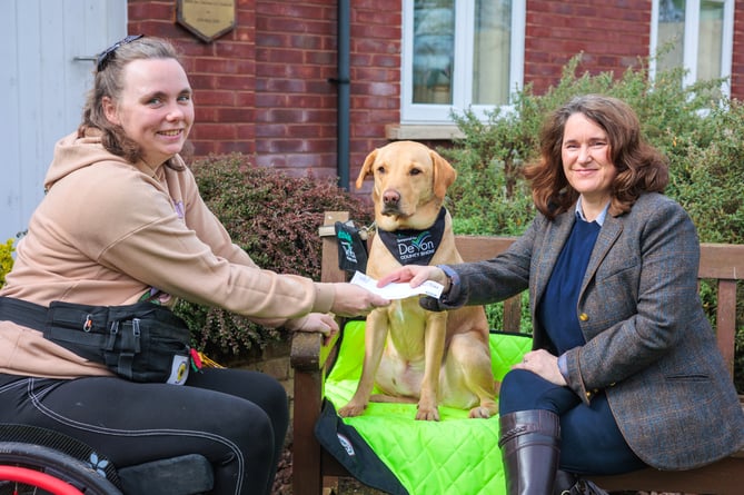 Lisa Moore (right), Show Manager, Devon County Show, presents Chloe Hammond with a cheque for £1,000 towards the upkeep of her assistance dog, Ocho.
