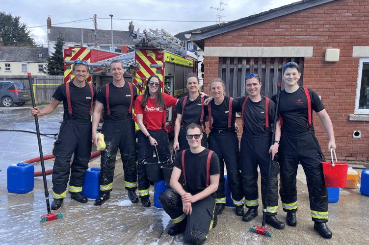 Some of the Crediton firefighters who took part in the charity car wash. AQ 9199