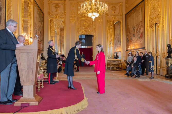 Laura Coryton receiving her honour from Anne, the Princess Royal.
