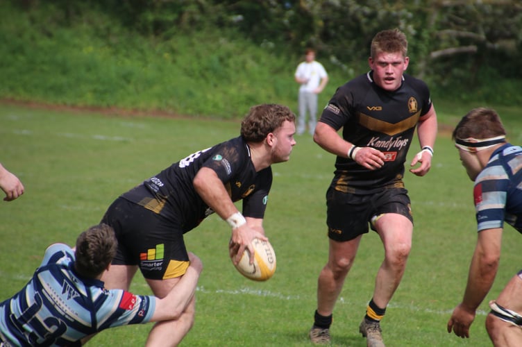 Crediton getting the ball away despite a tackle from Topsham.  AQ 3984
