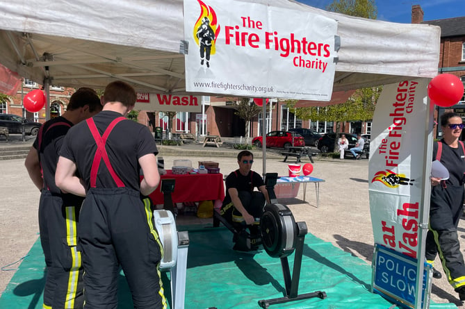 One of the firefighters rowing in Crediton Town Square.  AQ 0590