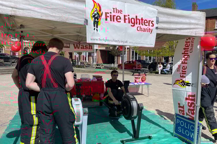 One of the firefighters rowing in Crediton Town Square. AQ 0590