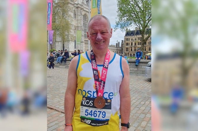 Ian Webber with his medal after completing this year’s London Marathon. 

