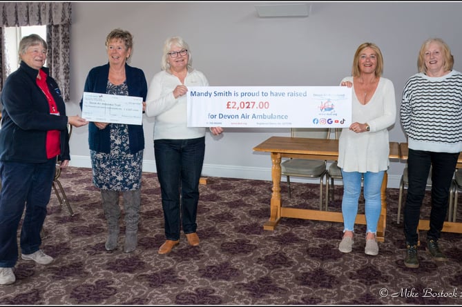 Marilyn MacQueen from Devon Air Ambulance, left, receives the cheque from the event from second left, Mandy Smith, Susie Bostock, Ali Birchwhite and Eleanor Wilson, at a get-together held at the Waie Inn on April 22.
