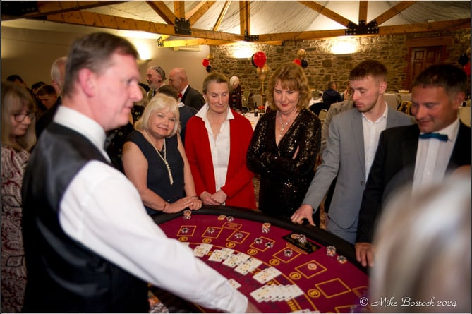 Watching proceedings at one of the tables at the Casino Night.  Image: Mike Bostock
