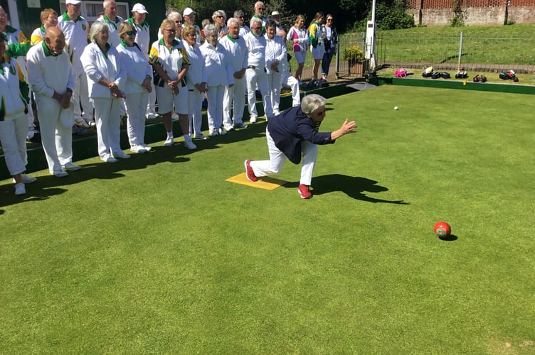 President Joan Martin bowling the first wood at Crediton Bowling Club.
