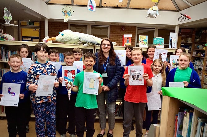Kathy Holland of Winkworth Crediton with winners of of the create/design a book cover competition at Landscore Primary School.
