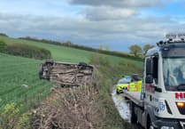 Car came to rest on side in field near Crediton
