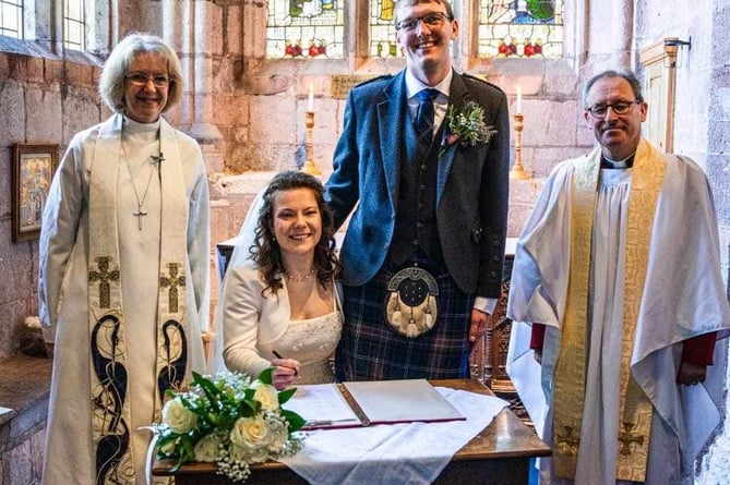 Signing the register with The Bishop of Crediton, left, and Rev Matthew Tregenza, right.  Image: Hannah Frost
