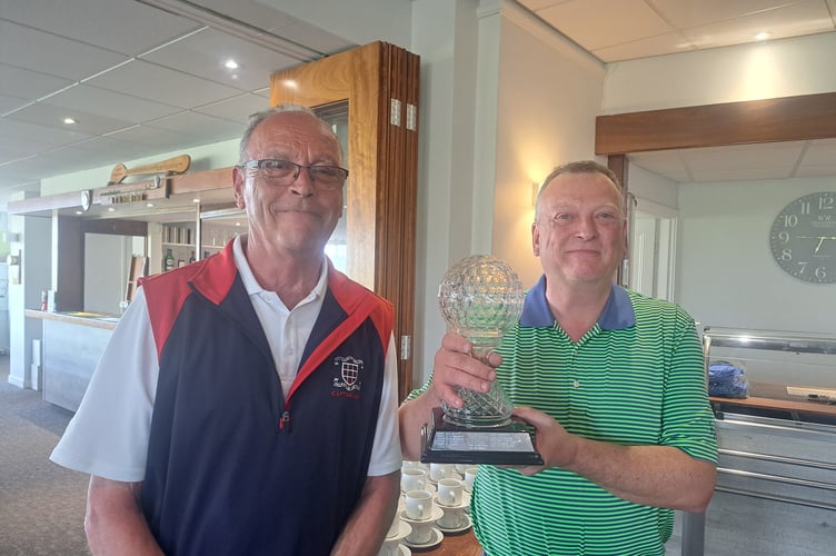 Andy Rogers receives the Gerry Mannell trophy from Peter Blinkhorn.