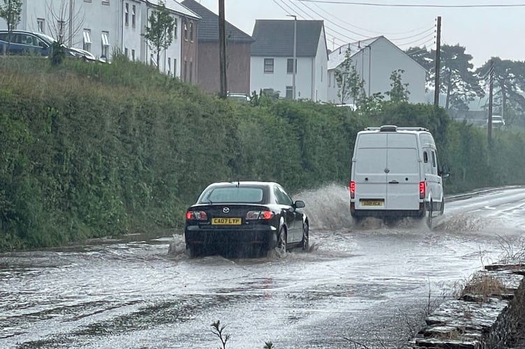 Exeter Road in Crediton was several inches deep with water.  AQ 3062
