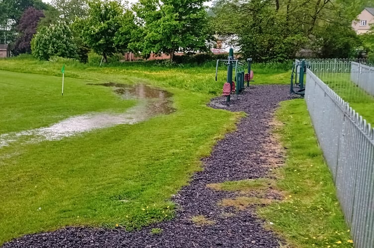 The water-logged pitch following the thunderstorm at about 3pm on Saturday.