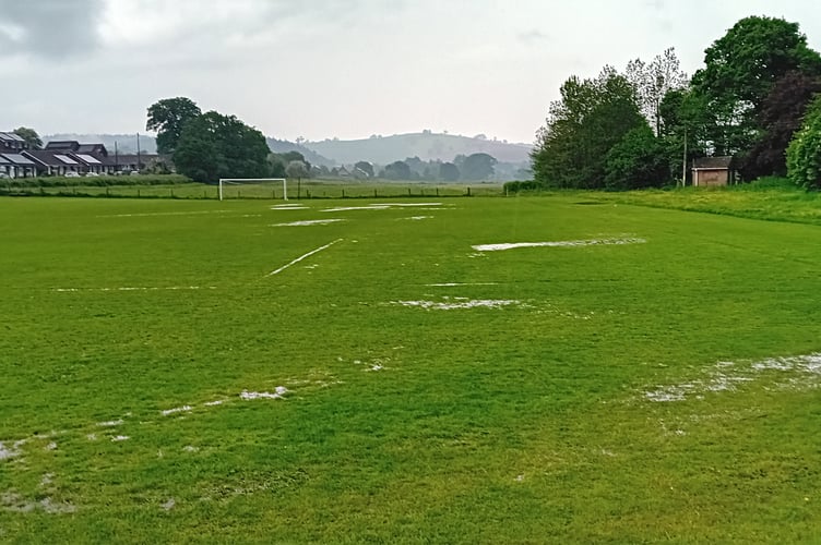 The water-logged pitch following the thunderstorm at about 3pm on Saturday.
