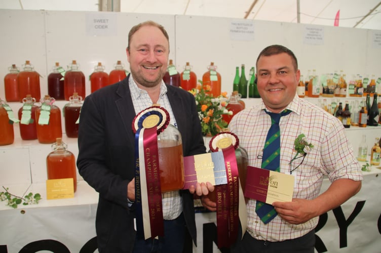 Barny Butterfield, left, from Sandford Orchards cider company received the Supreme Champion and Reserve Champion Awards at the Devon County Show, pictured with Cider Steward Pete Rich.  AQ 4191