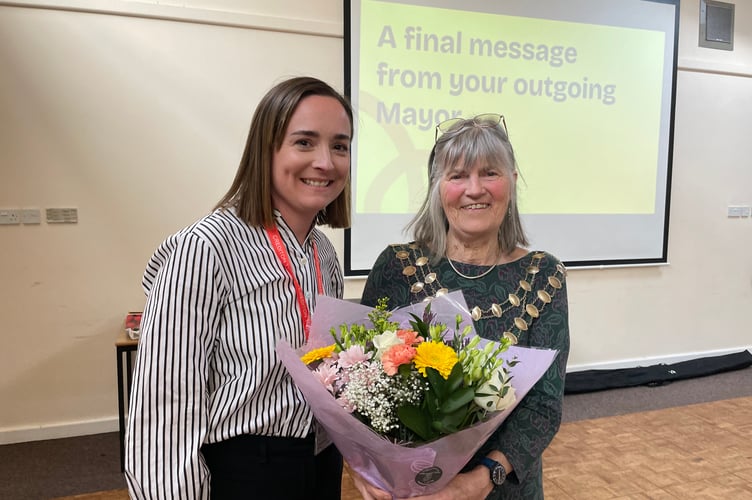 The Mayor of Crediton, Cllr Liz Brookes-Hocking, received flowers from the Town Council staff, presented by Emily Armitage, council receptionist. AQ 2987
