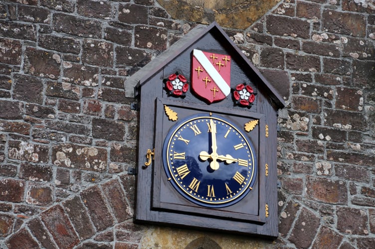 An image of the ornate clock which can be seen on Down St Mary Village Hall. AQ 4106