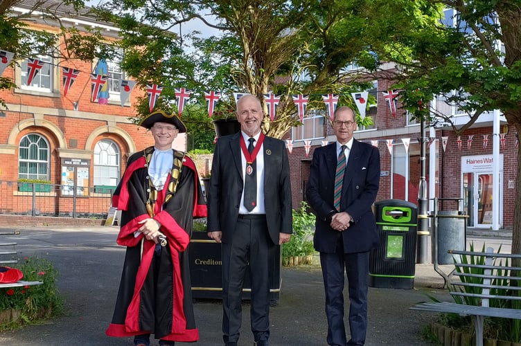 Town Crier Kevin Payne, Deputy Mayor Steve Huxtable and Crediton RBL President Henry Parker in Crediton Town Square for proclamation