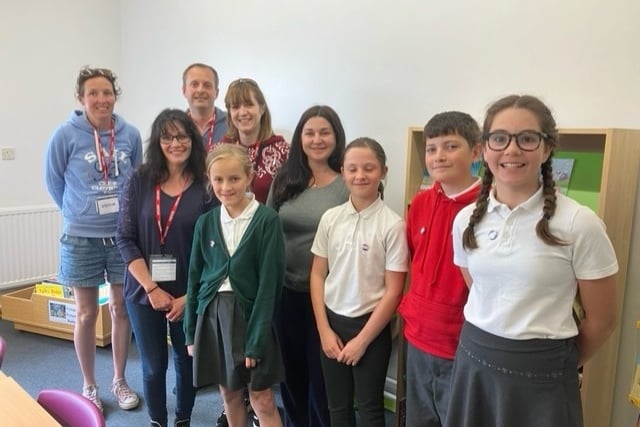 The school librarians and PTA members and staff in the library.