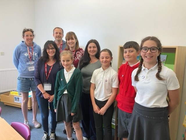 The school librarians and PTA members and staff in the library. 
