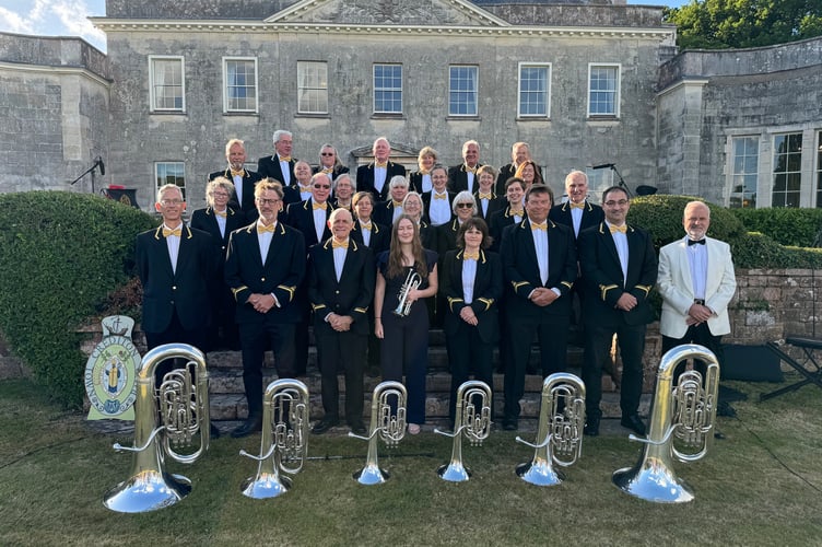 Crediton Town Band on the steps at Downes with right, Chris Richards, Chair and Acting Musical Director.  AQ 7075

