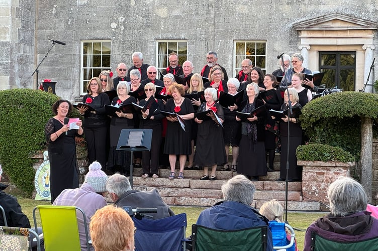 Tedburn Community Choir Musical Director announcing the next song. AQ 7155