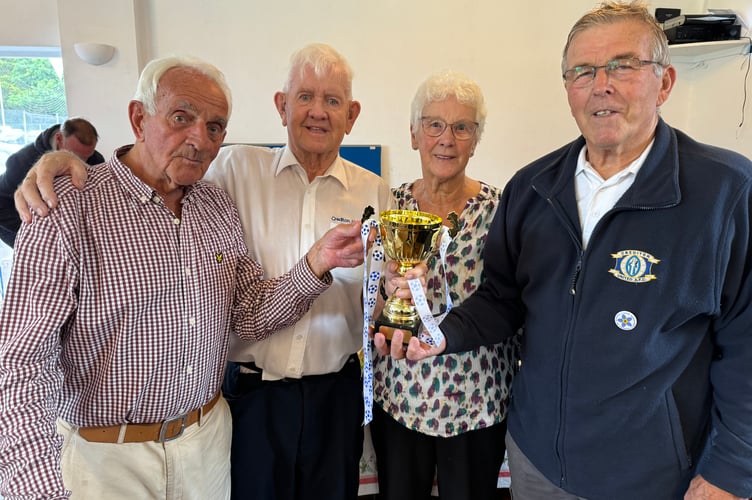 Dave Blanchford, second left, receiving the SW Peninsula League trophy for his long service from Ian Grinney, left and Chris Gillard, right, with Dave’s wife Monica.  AQ 7932