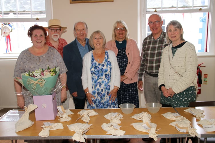 Ready for the money scramble with the bags of money for each age group on the table. From left, Deborah and Ed Phillips, Peter and Sue Older, Rev Christine Chandler and right, Mark and Angela Jocelyn who donate the coins every year. AQ 4756