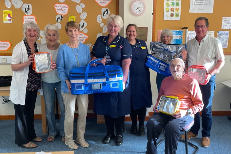 Members of Crediton Hospital League of Friends with two members of the Royal Devon Community Nursing team which work out of Crediton Hospital.  AQ 6109
