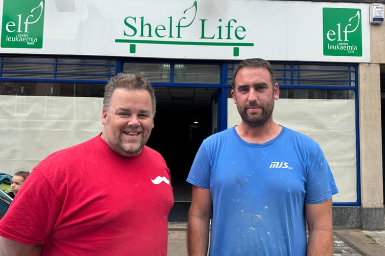 Pete Vallance, Head of Business Development at Devon Air Ambulance, left and Matt Scoins of MJS Building Maintenance, are busy preparing the charity shop for opening at the end of this month. AQ 8382