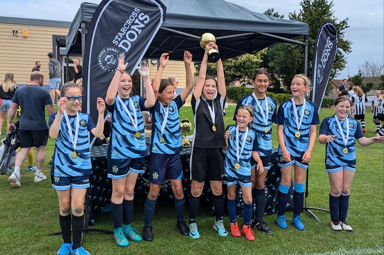 Crediton Youth U11 Girls celebrate their six-a-side tournament win at the Starcross Dons tournament.