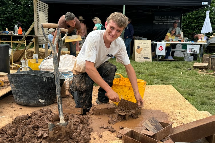 Demonstrating making cob bricks, one of the many traditional activities demonstrated at the Chagford Show. AQ 0620