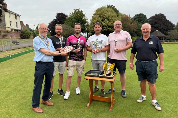 Runners-up in the Industrial Bowls tournament were Nomads A, Fred Oliver, President of Crediton Boniface Rotary, left, presenting the runners-up trophy to the team, from second left, Dan Yelland, Anthony Moss, Eddie Yeandle and Jay Harris, with , right, Rotarian Paul Radnor, one of the tournament organisers.  AQ 1173
