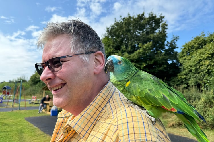 Mark from the New Inn at Coleford with special guest at the ceremony, Captain, the pub’s parrot. AQ 1347