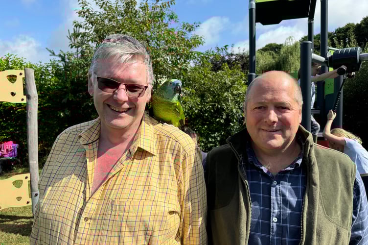 Mark from the New Inn with Captain, the celebrity parrot and the Chairman of the Parish Council Steve Smith. AQ 1380
