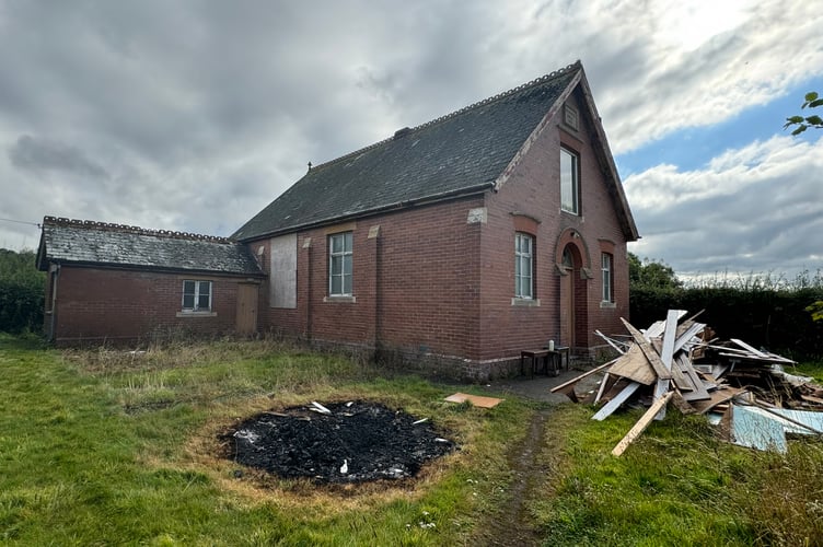 Yeoford Gospel Hall where a bonfire was lit on graves and building debris is piled high.  AQ 1699