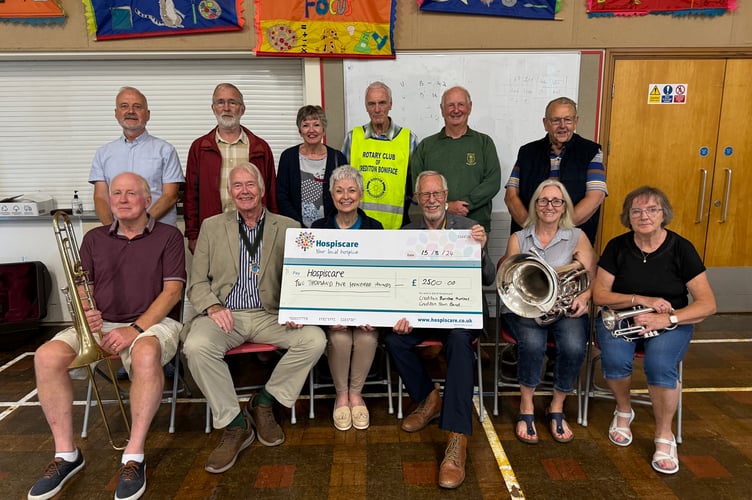 Rotarians Piers Rose, Sheila Ralph, Garry Adams, Paul Radnor, Paul Evans and Fred Oliver and band members Chris Richards, Arthur Arscott, John Cope, Muriel Power and Gill Sutton with Sarah Smith from Hospiscare receiving the cheque.  AQ 0834
