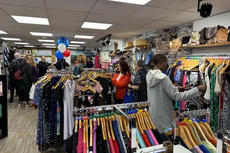 The first shoppers have a good look at the items for sale in the new Devon Air Ambulance charity shop.  AQ 2159