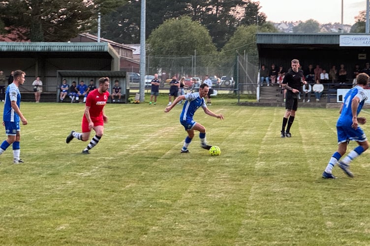 A Crediton player takes control. AQ 1818
