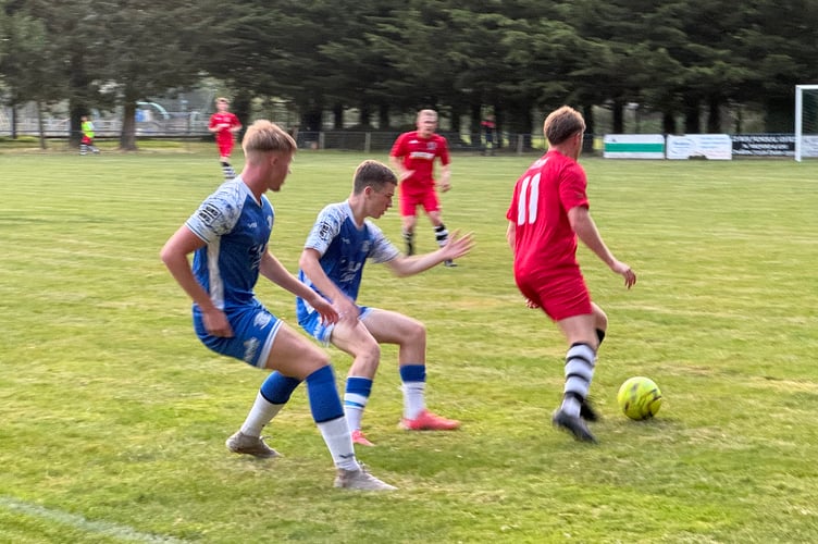 Two Crediton players ready to take on a Honiton player.  AQ 1813
